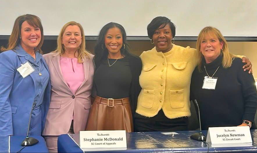 Several women lawyers taking a group photo